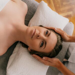 Woman receiving acupuncture therapy in a serene, indoor setting for wellness enhancement.